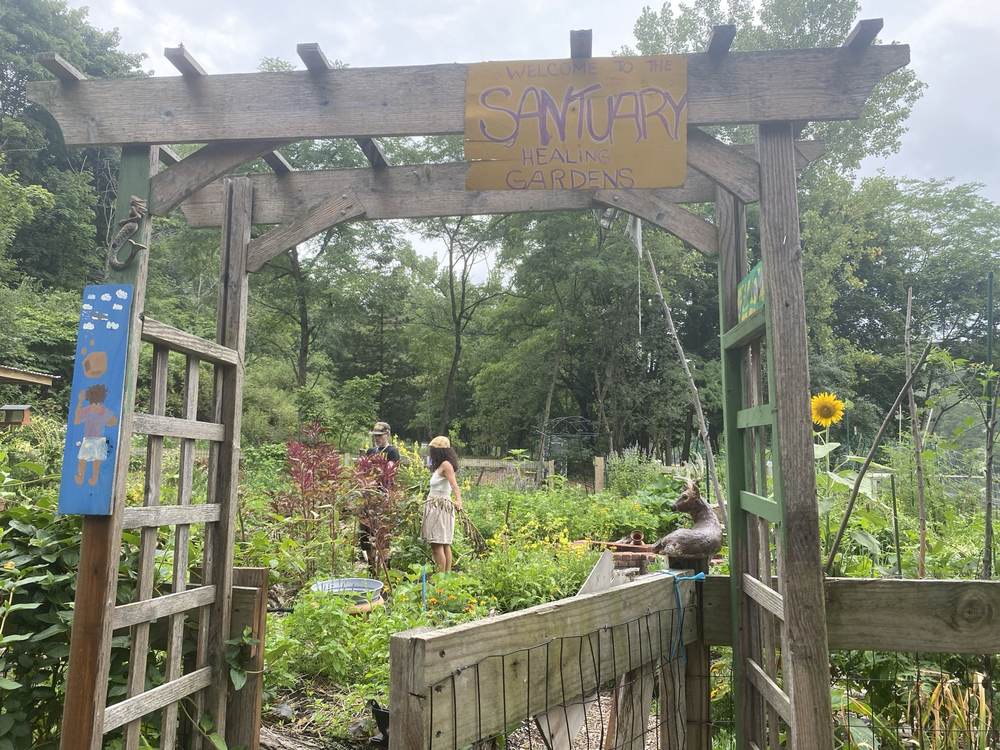 A wooden arbor gateway into the Sanctuary garden